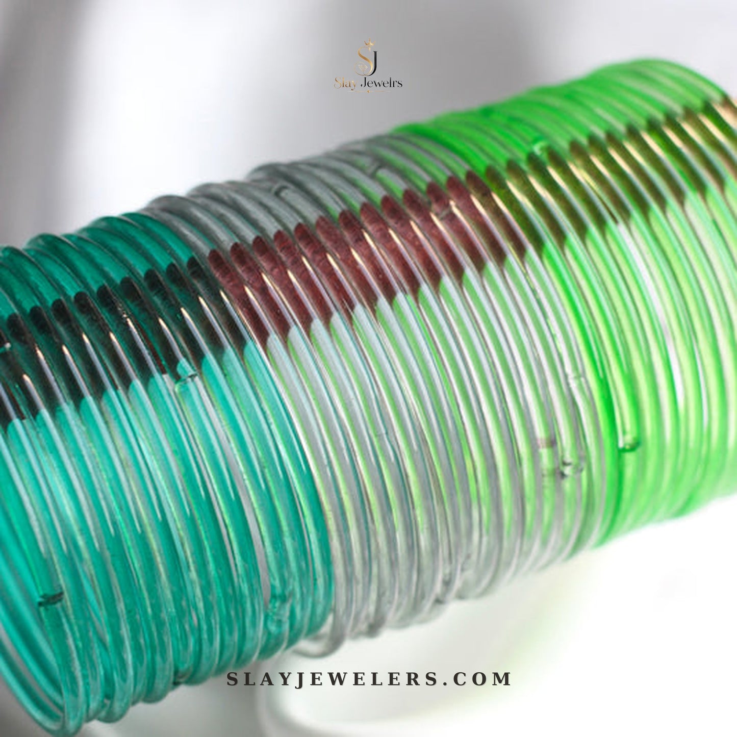 Emerald, crystal clear, and mint jelly bangle trio — Slay Jewelers
