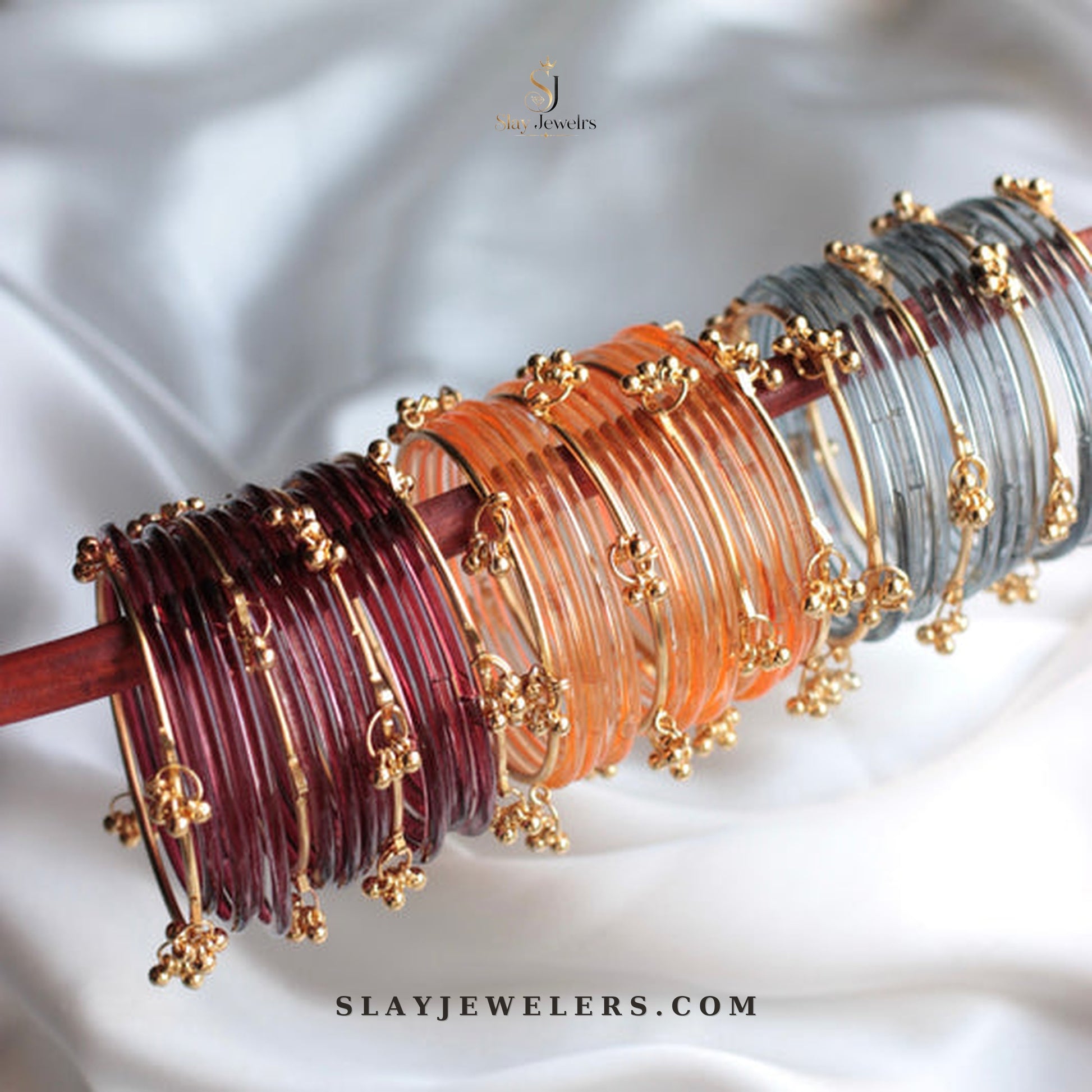 Three jelly bangle stacks in maroon orange and grey with gold Kashmiri charms — Slay Jewelers