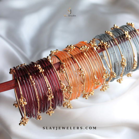 Three jelly bangle stacks in maroon orange and grey with gold Kashmiri charms — Slay Jewelers