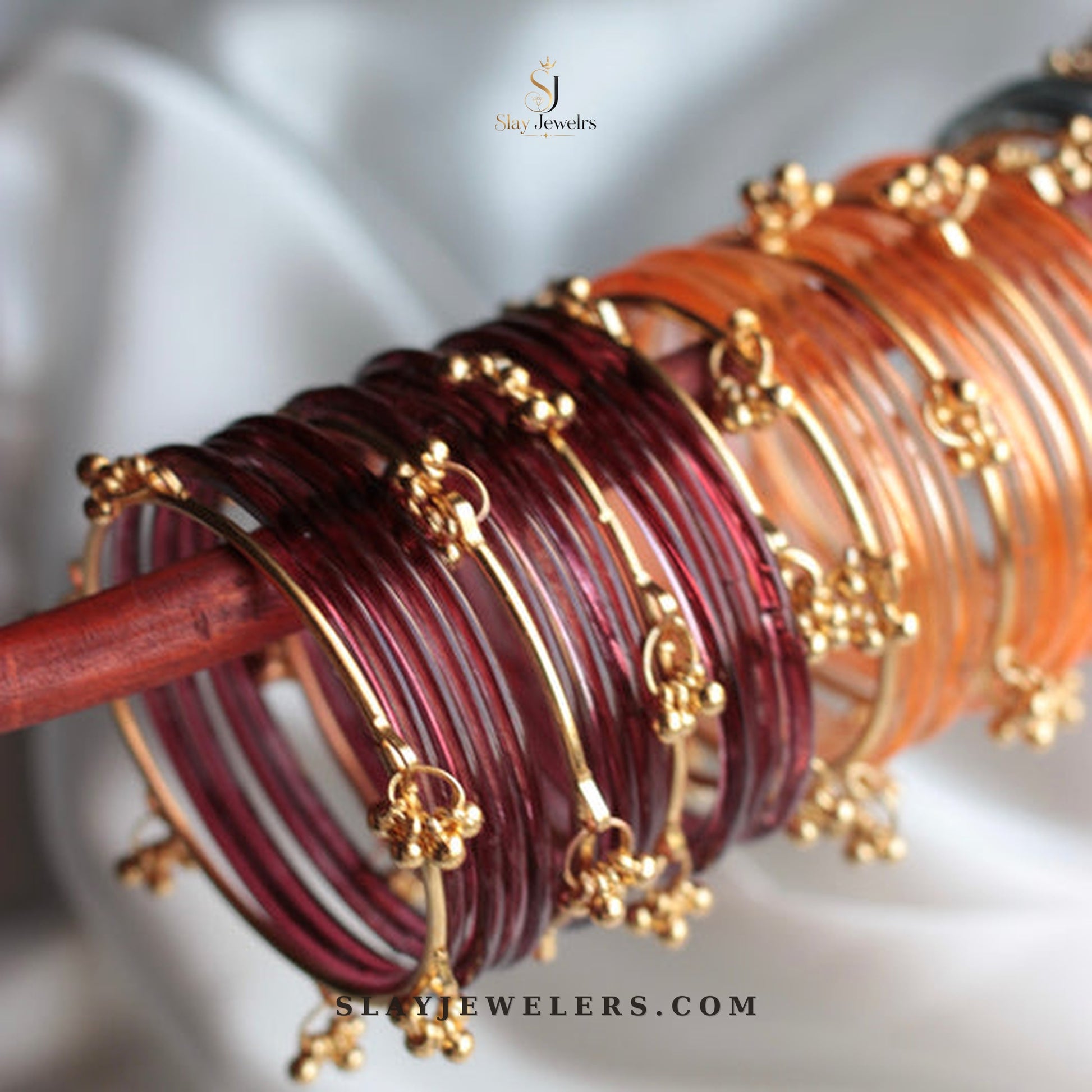 Maroon and orange amber jelly bangles with gold Kashmiri charms — Slay Jewelers
