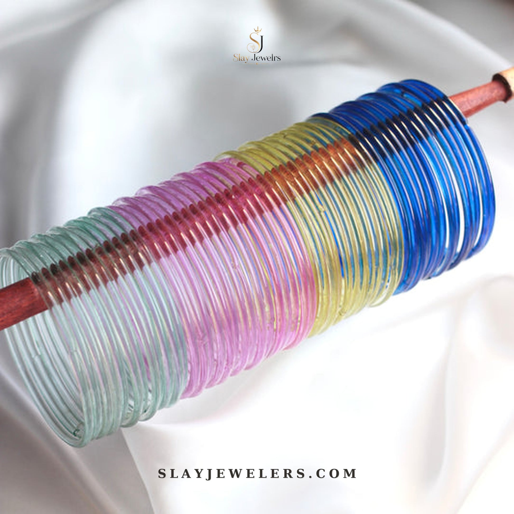 Pastel rainbow jelly bangles in teal, pink, yellow, and royal blue — Slay Jewelers